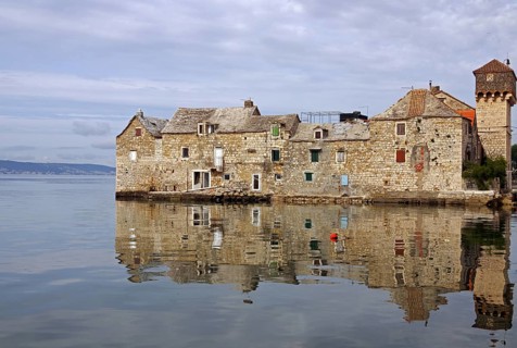 Old fortification from the Mediterranean reflected in the water, town of Kastela, Split, Dalmatia,