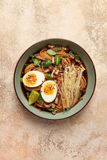 Soba, buckwheat noodles, with enoki mushrooms, shimeji and boiled egg, top view, homemade, no