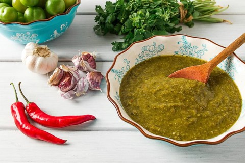 Tkemali sauce, traditional Georgian cuisine, green cherry plum, with ingredients for sauce,