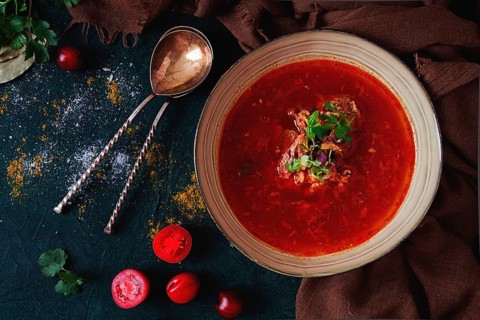 Traditional Georgian dish spicy tomato, Kharcho soup, on a dark background, no people, top view