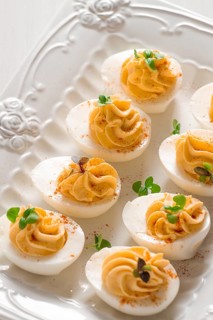 Boiled eggs stuffed with yolk with mayonnaise, on a white plate, selective focus, blurry, close-up,