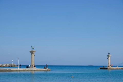 Elafos and Elafina, stag and hind, sculptures on columns, harbour entrance Mandraki harbour,