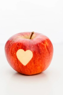 An apple with a heart, carved, symbol of love, Valentine's Day, Mother's Day, studio