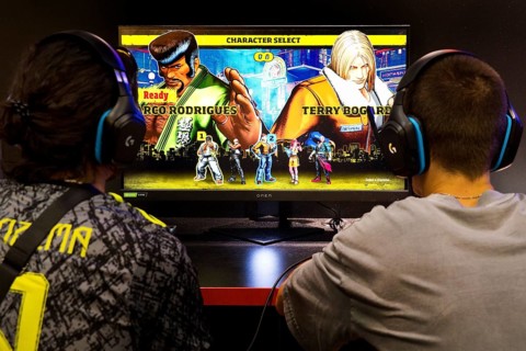 Two men in front of a screen with a computer role-playing game, Gamescom trade fair, the world's