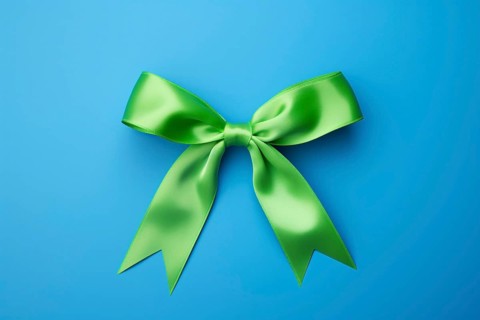 Green silk ribbon on blue background. KI generiert, generiert AI generated