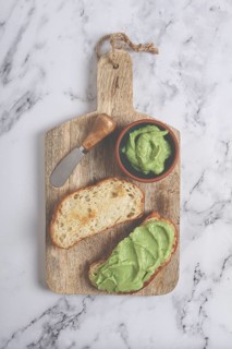 Ciabatta with avocado pasta, breakfast, on a chopping board, top view, homemade, no people