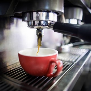 Symbol photo on the subject of making coffee. Coffee runs out of a Siebtraeger coffee machine into