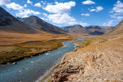 Burkhan valley with blue river, mountain landscape with golden meadows, Terskey Ala-Too, Tien Shan,