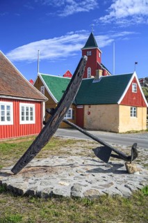 Historic building and anchor in front of blue sky, Museum, Sisimiut, West Greenland, Greenland,