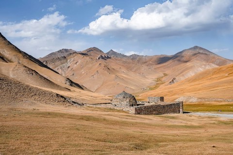 Historic caravanserai Tash Rabat from the 15th century, with yellow hills, Atbashy district in the