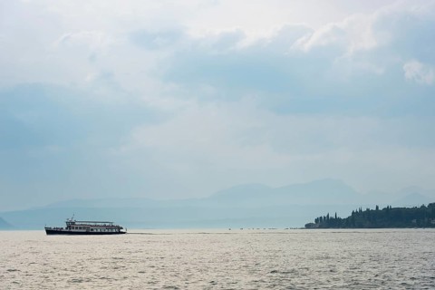 Historic ferry boat in the evening light, tourism, evening mood, sunset, Lake Garda, Malcesine,