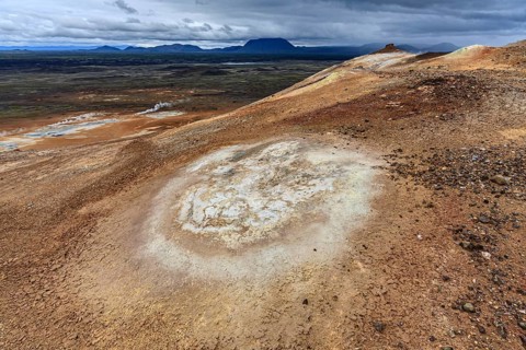 Hot springs and geothermal area in front of mountain landscape in summer, cloudy, sulphur qu,