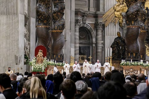 Pope Francis prays during Holy Mass in St Peter's Cathedral in the background columns of canopy by