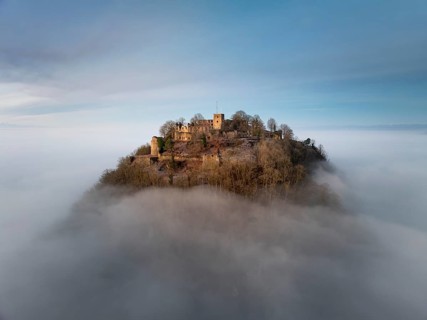 Aerial view of the Hegau volcano Hohentwiel with the upper fortress ruins illuminated by the rising