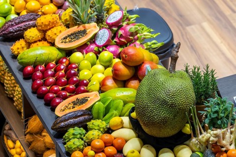 Exotic fruits, lychee, jackfruit, dragon fruit, mango and citrus fruits presented on a table,