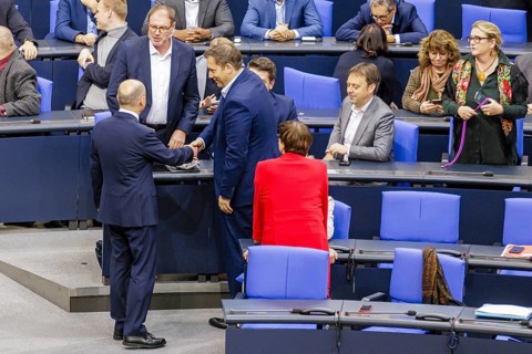 Olaf Scholz (SPD), Federal Chancellor, greets Lars Klingbeil in the plenary chamber in front of the
