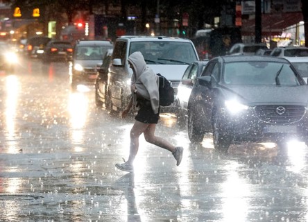 People try to protect themselves from the rain on Potsdamer Strasse. After weeks of heat, the first
