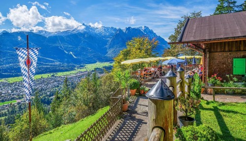 St. Martinshütte with restaurant terrace and view of the valley and Zugspitze group 2962m.