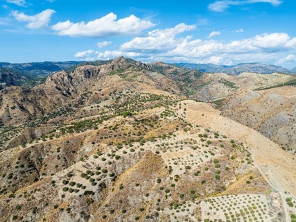 Mountains and Olive groves around Ghost Town from a drone, Pentedattilo Village, Calabria, Italy,