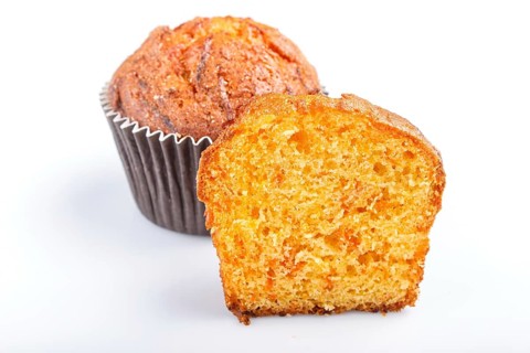 One and a half carrot muffin isolated on white background. closeup