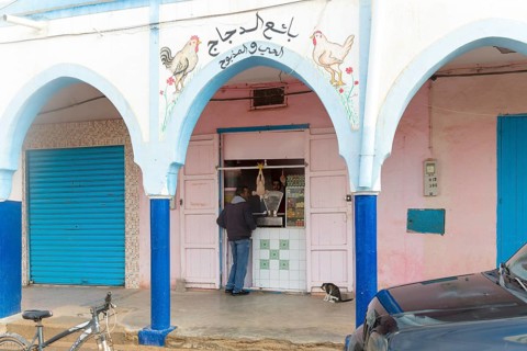 Shop selling poultry historic arcaded shopping street in town centre, Mirleft, southern Morocco,