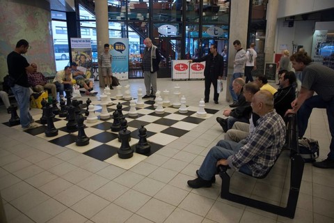 Men playing chess with a giant set of board and pieces in the central library, Rotterdam,