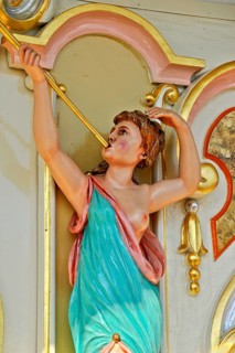 Wooden figure, colourfully painted, woman blowing fanfare, bosom free, old Hooghuys organ on