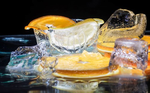 Transparent slices of fresh oranges and lemons on the glass with ice