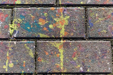 Multicolored spots of paint on a concrete slab