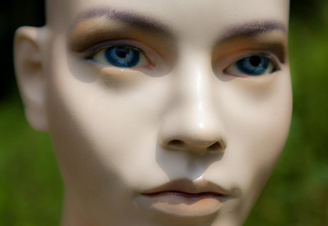 Female mannequin face doll model woman bald blue eyes close-up