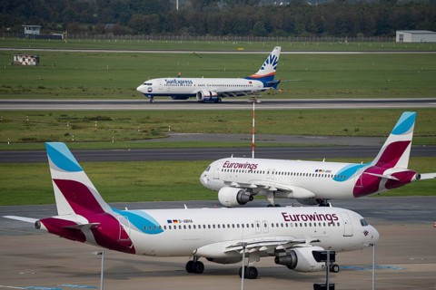 Düsseldorf Airport, SunExpress Boeing 737 on landing, Eurowings Airbus in parking position, outside