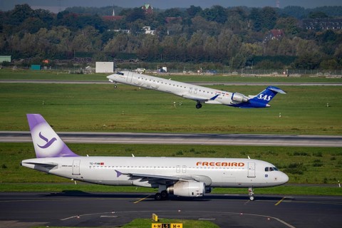Düsseldorf Airport, SAS Scandinavia Bombardier CRJ-900 on take-off, Freebird Airbus A320 on the