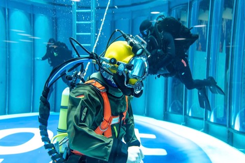 Federal Navy mine divers present themselves in the diving tank in the diving hall at BOOT 2024, the