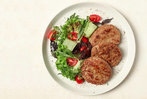 Fried cutlets, minced beef, with vegetable salad, top view, no people