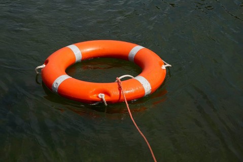 Lifebuoy with lifeline in the water, distress at sea, drowning, accident, danger, shipping,