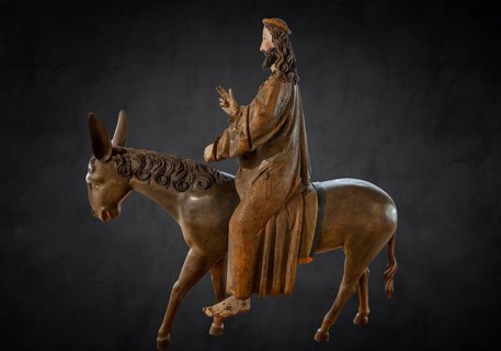 Palm donkey, detail of donkey's head, wooden figure from 1470, on dark background, Franciscan