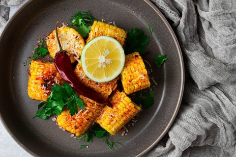 Grilled corn with spices, top view, no people, homemade