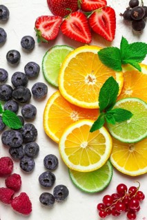 Mix of fruits and berries, set, assortment, sliced citrus fruits, raspberries, blueberries, mint