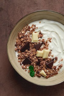 Yogurt with chocolate muesli, breakfast, close-up, fork on top, no people
