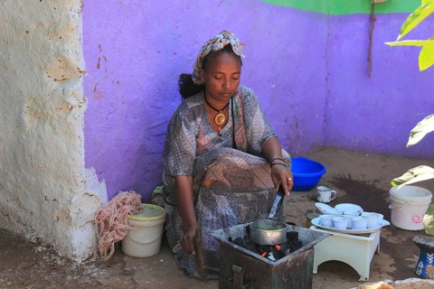 In the highlands of Abyssinia, in the village of Sina, young woman roasting coffee for the coffee