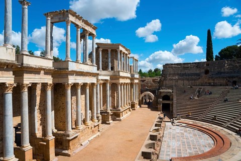 View of an ancient Roman theatre with marble columns and preserved ruins under a sunny sky, Teatro