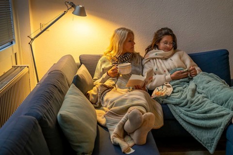 Symbolic image energy saving, cold winter, energy crisis, cold flat, mother and daughter lying on