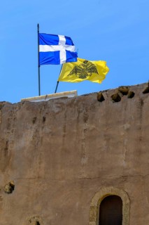Top left flag of Crete behind it flag with symbol of Eastern Orthodox Greek Orthodox Church yellow