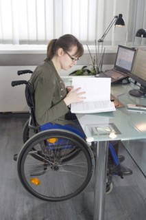 Young woman in a wheelchair at her workplace, Berlin, 18/01/2017