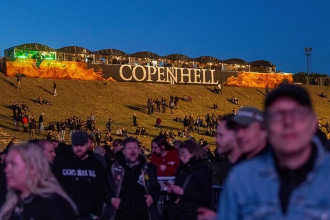 Copenhagen, Denmark - 19 June 2024: Festivalgoers in front of the logo at the Copenhell Metal