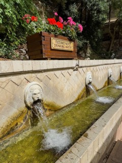 Partial view of lion fountain Venetian fountain Kefalovrisi with 25 waterspouts in the shape of