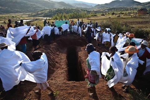 People are participating in a famadihana, a funerary tradition also known as the turning of the