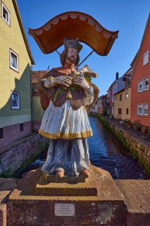 Figure of a saint with Jesus on the cross and canopy on the Stone Bridge in Amorbach, Lower