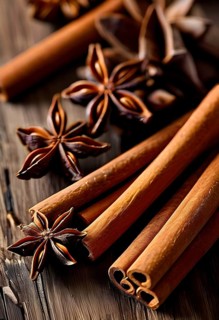 Christmas spices like cinnamon sticks, star anise, and cloves arranged on a wooden table, with soft