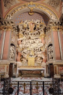 Chancel and high altar with altar reredos, decorations and sculptures of the baroque church